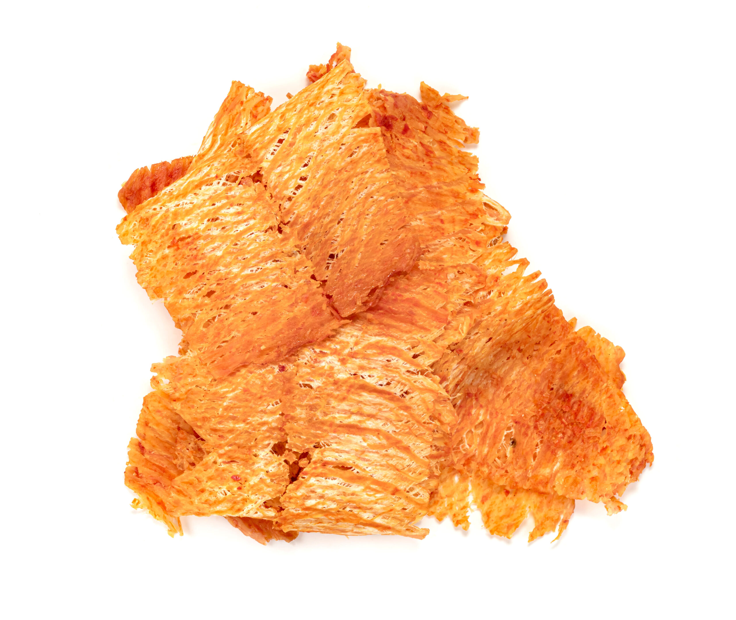 Spicy dried squid snack pieces with a crispy, fibrous texture on a white background